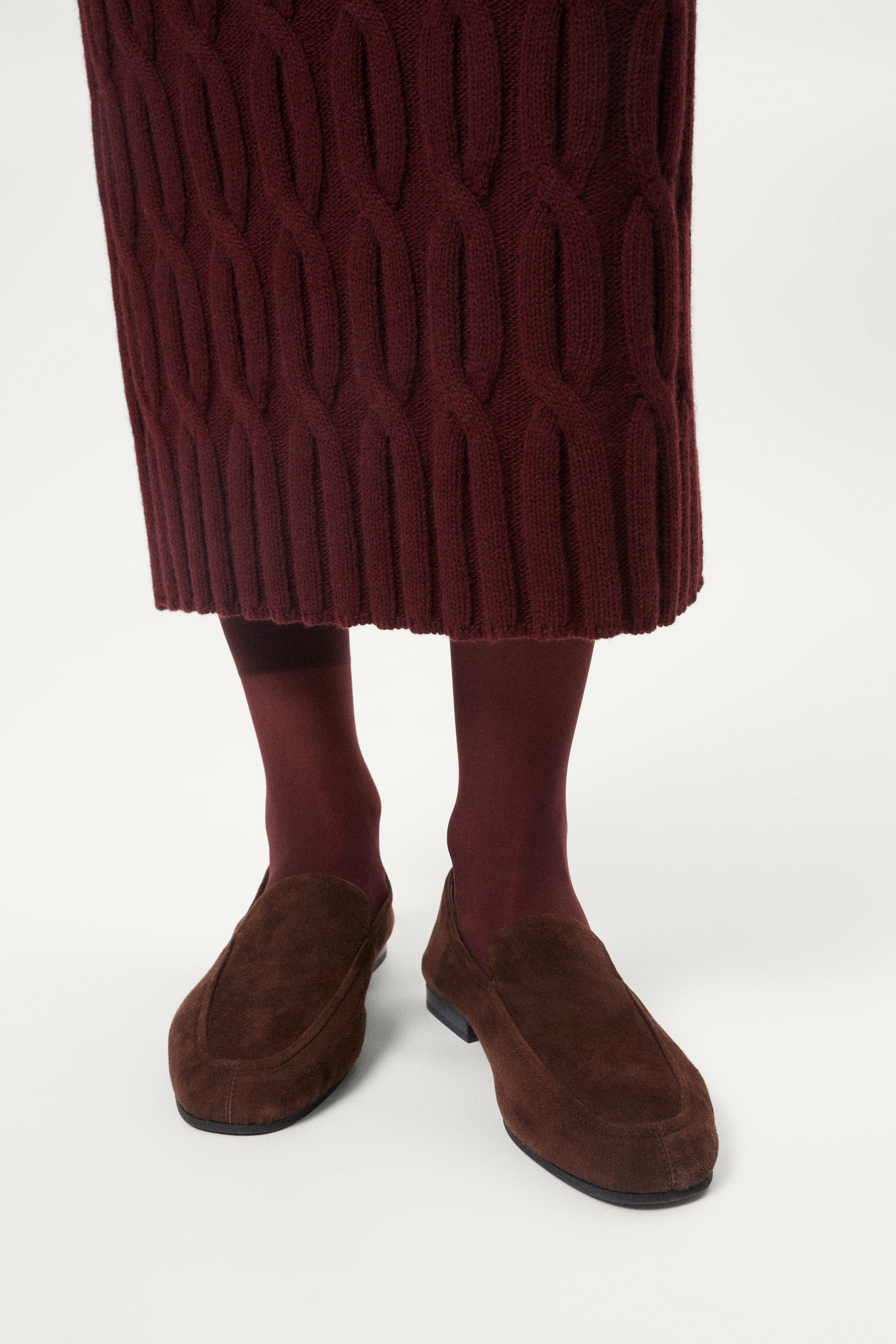 woman wearing a burgundy Woolen Cable knit skirt