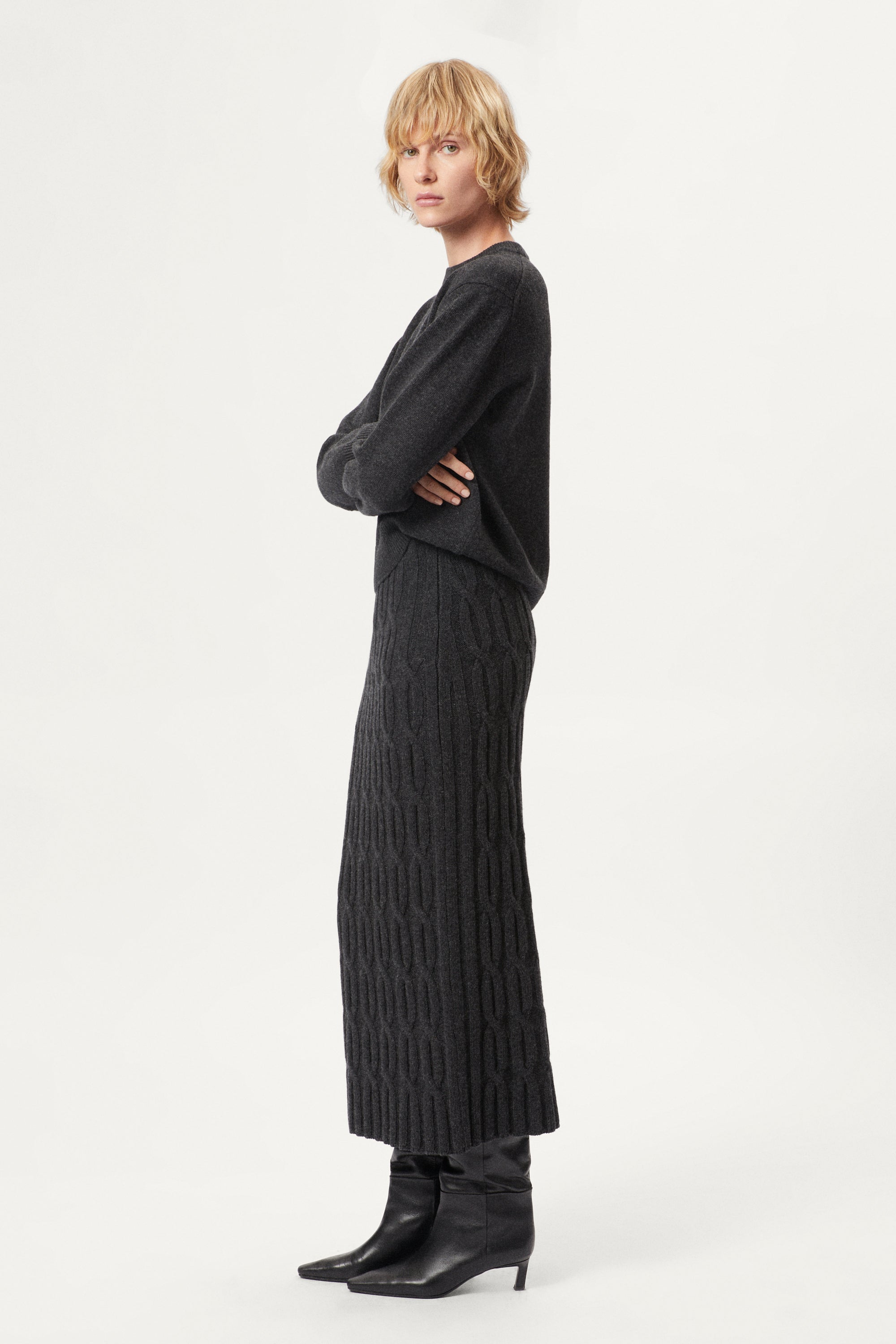 woman wearing a dark grey Woolen Cable knit skirt